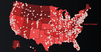 A map of the United States in red with white dots for groups the Southern Poverty Law Center brands "hate groups" or "antigovernment extremist groups."