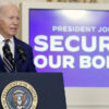Joe Biden at the White House podium with a screen behind him that says securing our border