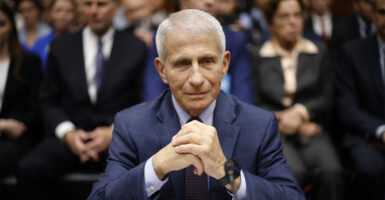 anthony fauci sitting at a witness table in a house hearing room