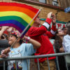 A child waves a rainbow flag at a gay pride parade during the month of June in Los Angeles.