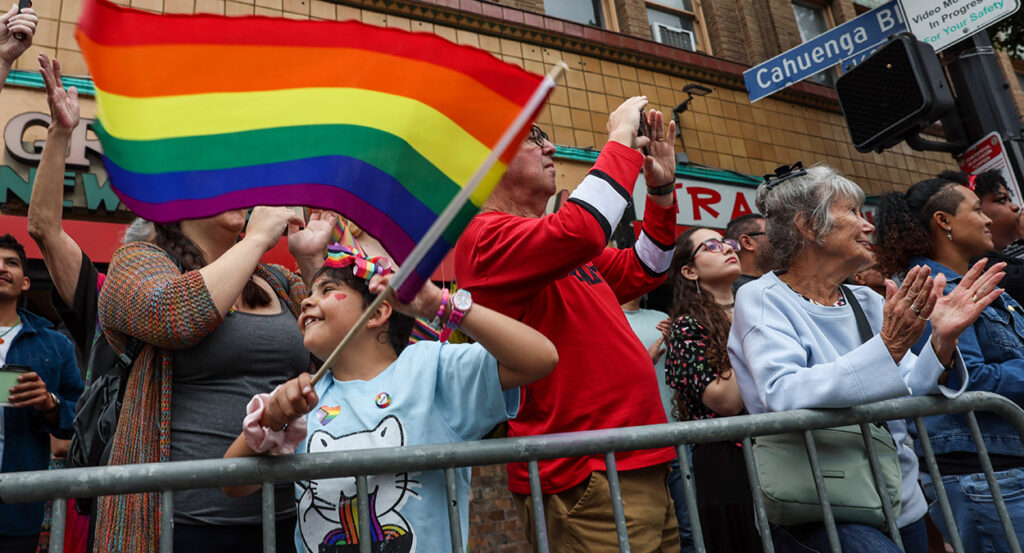 A child waves a rainbow flag at a gay pride parade during the month of June in Los Angeles.