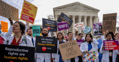 Doctors dressed in lab coats protesting in front of the Supreme Court in favor of abortion