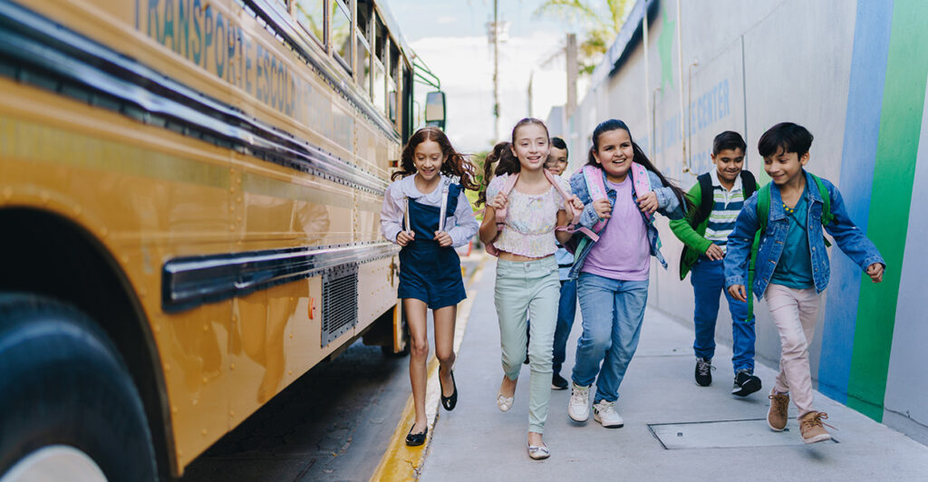 Kids run off the school bus.