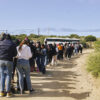 Illegal aliens wait to board a Border Patrol bus Wednesday after crossing the U.S.-Mexico border into Jacumba Hot Springs, California.