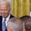 President Joe Biden smirking.