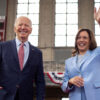 Joe Biden smiles and Kamala Harris waves.