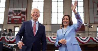 Joe Biden smiles and Kamala Harris waves.