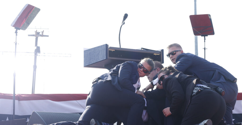 Secret Service members dogpile on top of Donald Trump.
