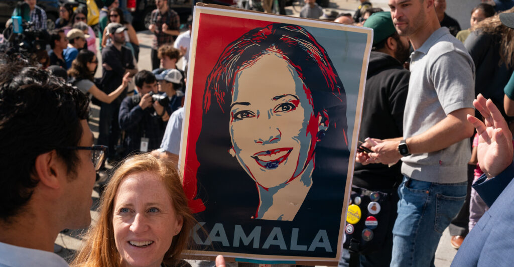 A supporter holds a sign of Kamala Harris at a Democratic Party rally.