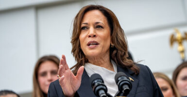 Kamala Harris gestures in front of a podium