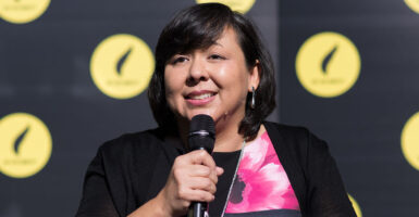 Margaret Huang holds a black microphone