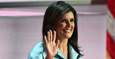 Nikki Haley waves with a grin on her face