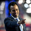 Vivek Ramaswamy in a suit points from the RNC stage