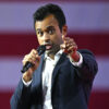 Vivek Ramaswamy speaking into a microphone and pointing.