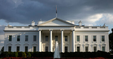The White House underneath dark clouds.