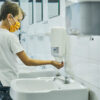 A little boy washes his hands.