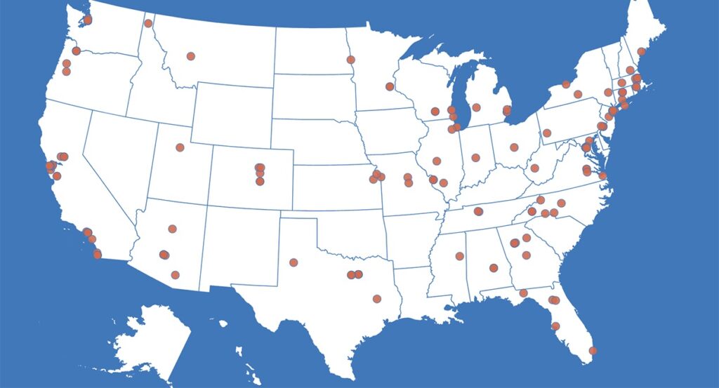 A blue and white map of the United States with red dots on it