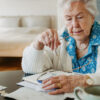 Senior woman calculates money and monthly pension.