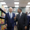 President Joe Biden walks with U.S. Representative Steven Horsford, D-Nevada, down a grocery store aisle.