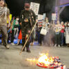 Anti-Israel protesters burn an American flag outside the DNC.