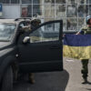 Ukrainian soldiers in Russia holding up the Ukrainian flag