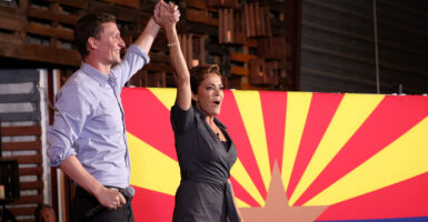 Kari Lake and Blake Masters in front of an Arizona flag