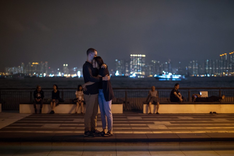 Mourners hug each other during a vigil in Hong Kong, China. (Photo: Jerome Favre/Newscom)
