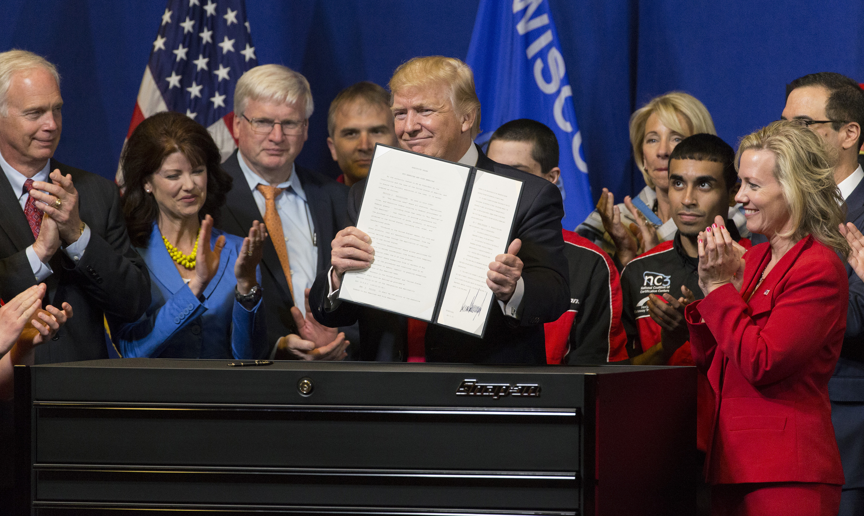 President Donald Trump announces an executive order that directs federal agencies to suggest changes to the H1-B visa program, to ensure visas are awarded to the most skilled, best-paid immigrant workers. (Photo: Mark Hoffman/TNS/Newscom)