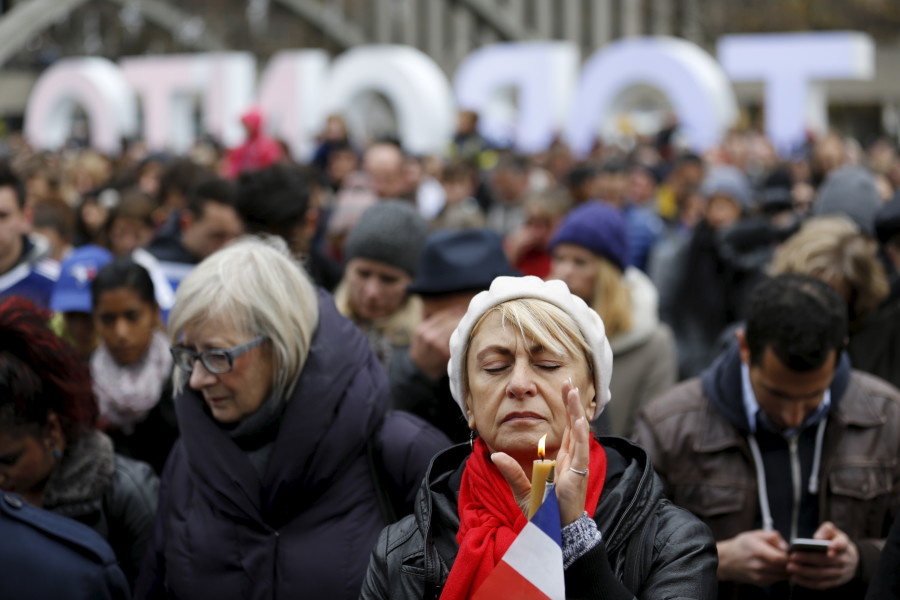 Lena Polyvyannaya of Toronto closes her eyes during a moment of silence outside city hall in Toronto, Canada. (Photo: REUTERS/Chris Helgren/Newscom)