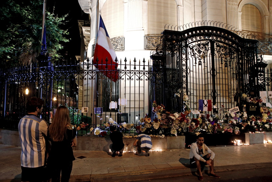 People light candles and stand outside the French embassy in Buenos Aires, Argentina. (Photo: REUTERS/Marcos Brindicci/Newscom)