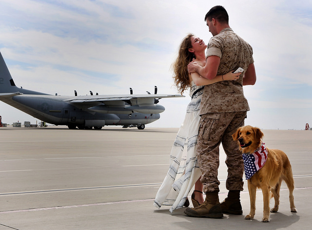 Cpl. Daniel G. Dillender is reunited with his wife, Angelica Dillender, and their dog Bella at Marine Corps Air Station Miramar, Calif., March 20, 2014. Dillender was deployed in support of Operation Enduring Freedom. (Photo: U.S. Marine Corps photo by Sgt. Keonaona C. Paulo/ Released)