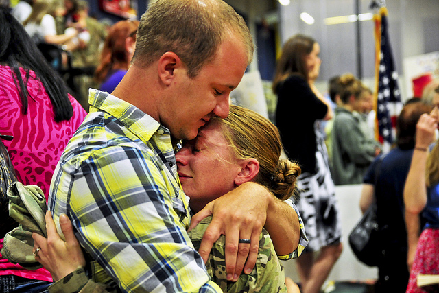 Spc. Jessie Nelson, 4th Brigade, 2nd Infantry Division, hugs her husband, Matt, after her eight-month deployment to Afghanistan in support of Operation Enduring Freedom in 2013. (Photo: U.S. Army photo by Sgt. Kimberly Hackbarth, 4th SBCT, 2nd ID Public Affairs Office)