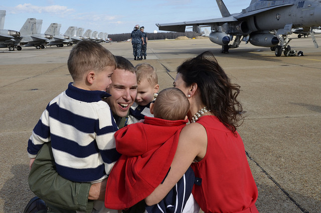 Lt. Cmdr. Nate Lyon is reunited with his wife and children during a homecoming celebration for the squadron in 2012  after a six month deployment supporting Operation Enduring Freedom, maritime security operations and theater security cooperation efforts. (Photo: U.S. Navy photo by Mass Communication Specialist 2nd Class Antonio P. Turretto Ramos/Released)