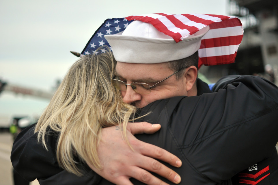 Boatswain's Mate 2nd Class Anthony Gitar, assigned to the aircraft carrier USS George H.W. Bush (CVN 77), hugs his wife, Lori, following the ship's return to Naval Station Norfolk. George H.W. Bush completed its first combat deployment in support of Operations Enduring Freedom and New Dawn. (U.S. Navy photo by Mass Communication Specialist 2nd Class Timothy Walter/Released)