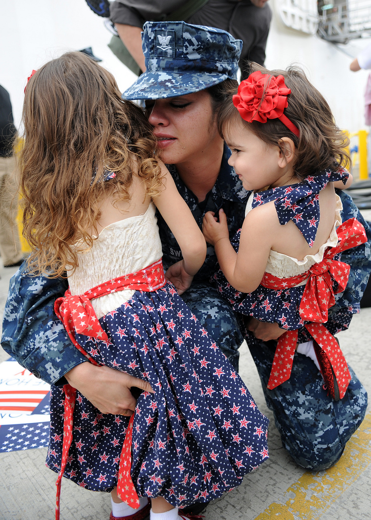U.S. Navy Hospital Corpsman Jerrilynn Sweat hugs her daughters during a homecoming ceremony in San Diego, Calif., Sept. 21, 2010  following a five-month deployment to Vietnam, Cambodia, Indonesia and Timor-Leste. (Photo: DoD photo by Mass Communication Specialist 2nd Class Chelsea Radford, U.S. Navy/Released)