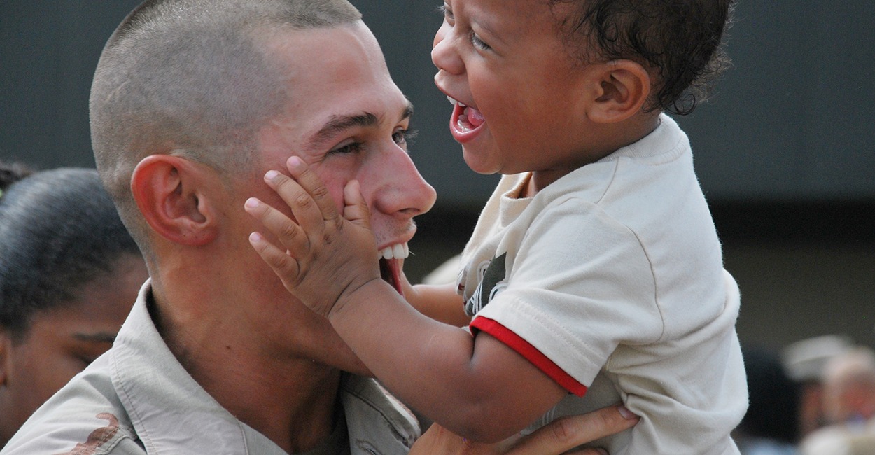 A U.S. Navy Seabee is welcomed home by his son in Gulfport, Miss., July 21, 2010, after returning home from a five-month deployment to Afghanistan in support of the surge ordered by President Barack Obama. (Photo: U.S. Navy photo by Equipment Operator 3rd Class Mikayla Mondragon/Released)